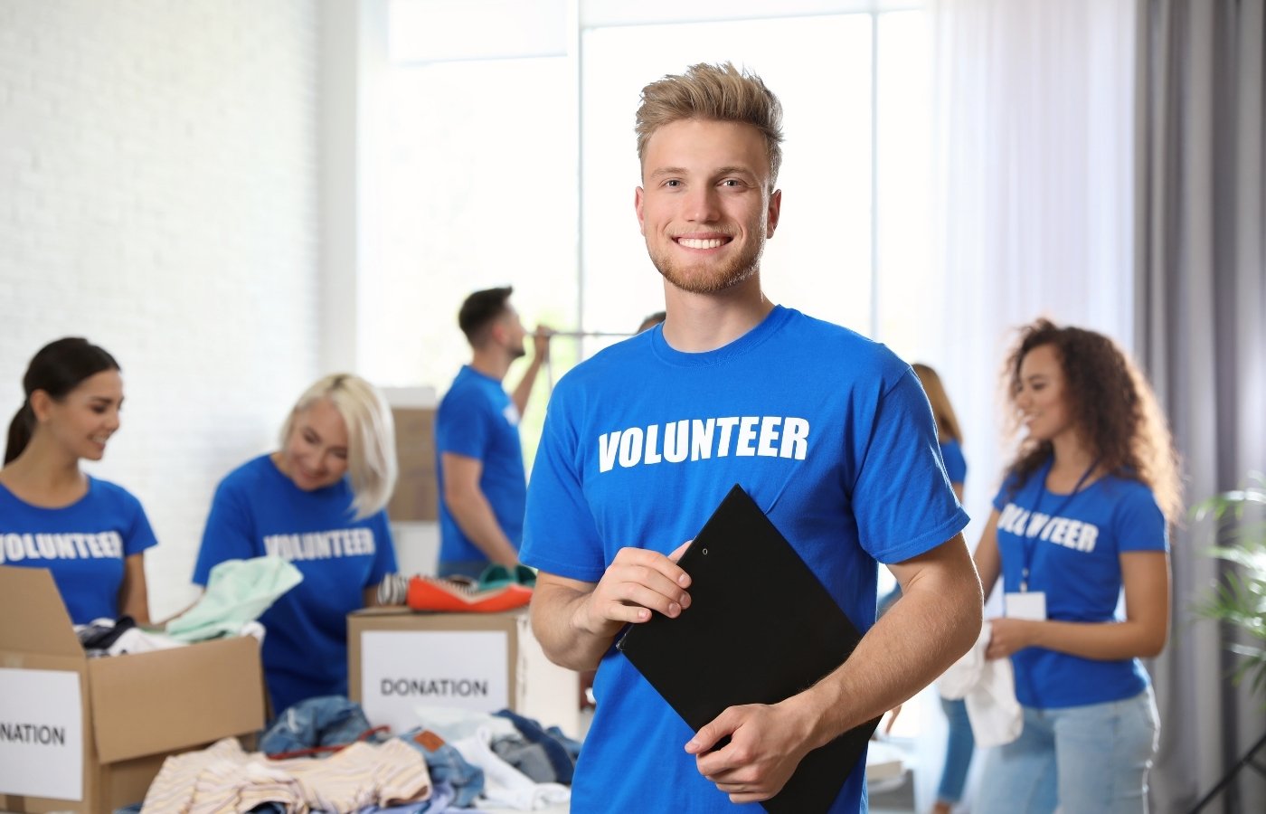 Support staff member listening to a community member and taking notes